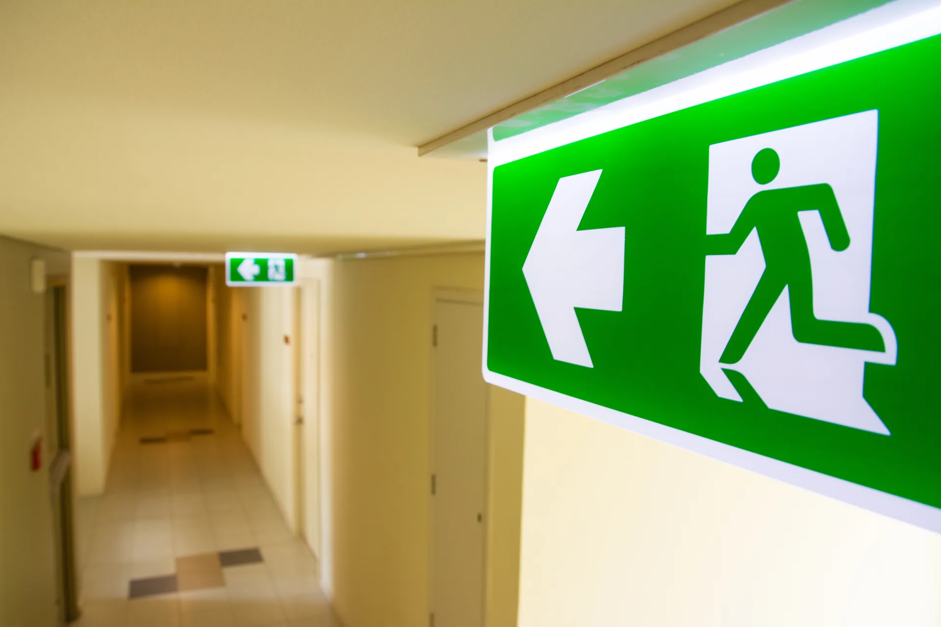 Illuminated emergency exit sign in a commercial building