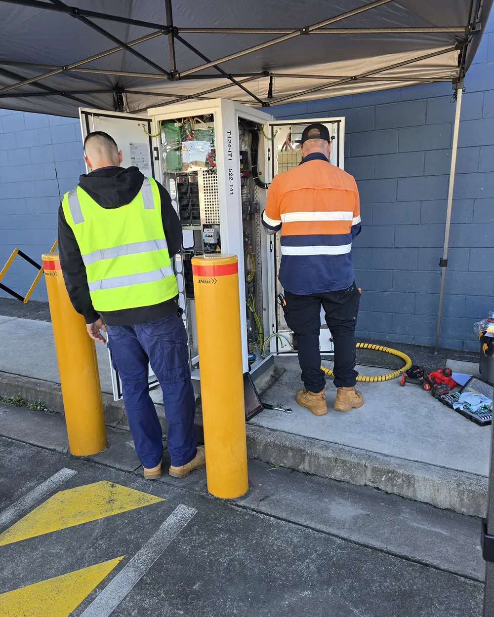 Technicians repairing electrical infrastructure at an operational facility