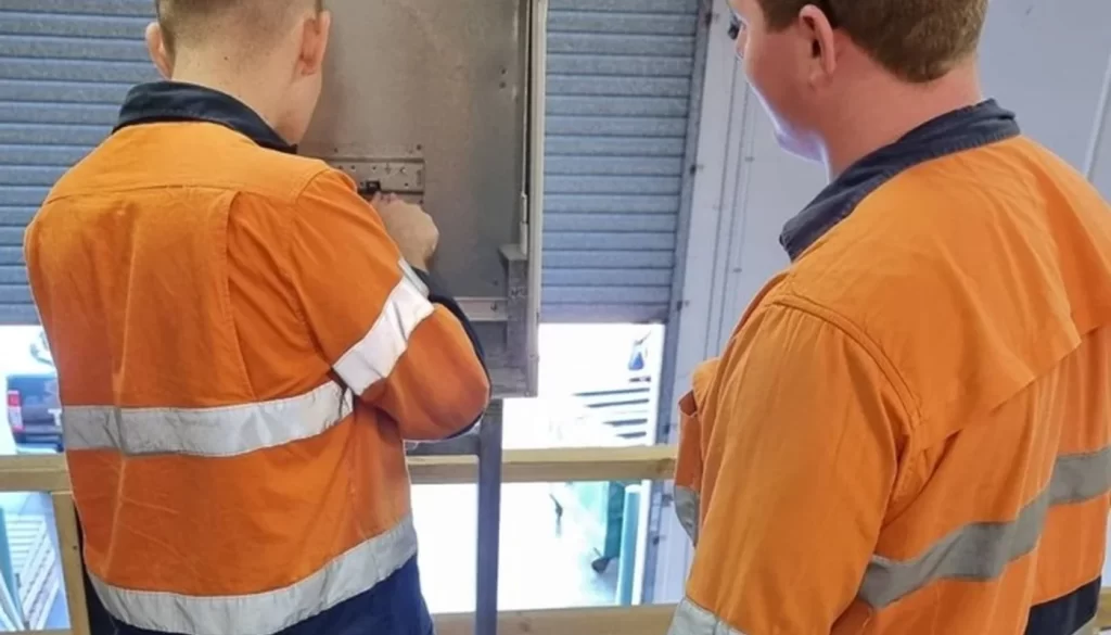 Two EDC Systems apprentices learning practical electrical skills