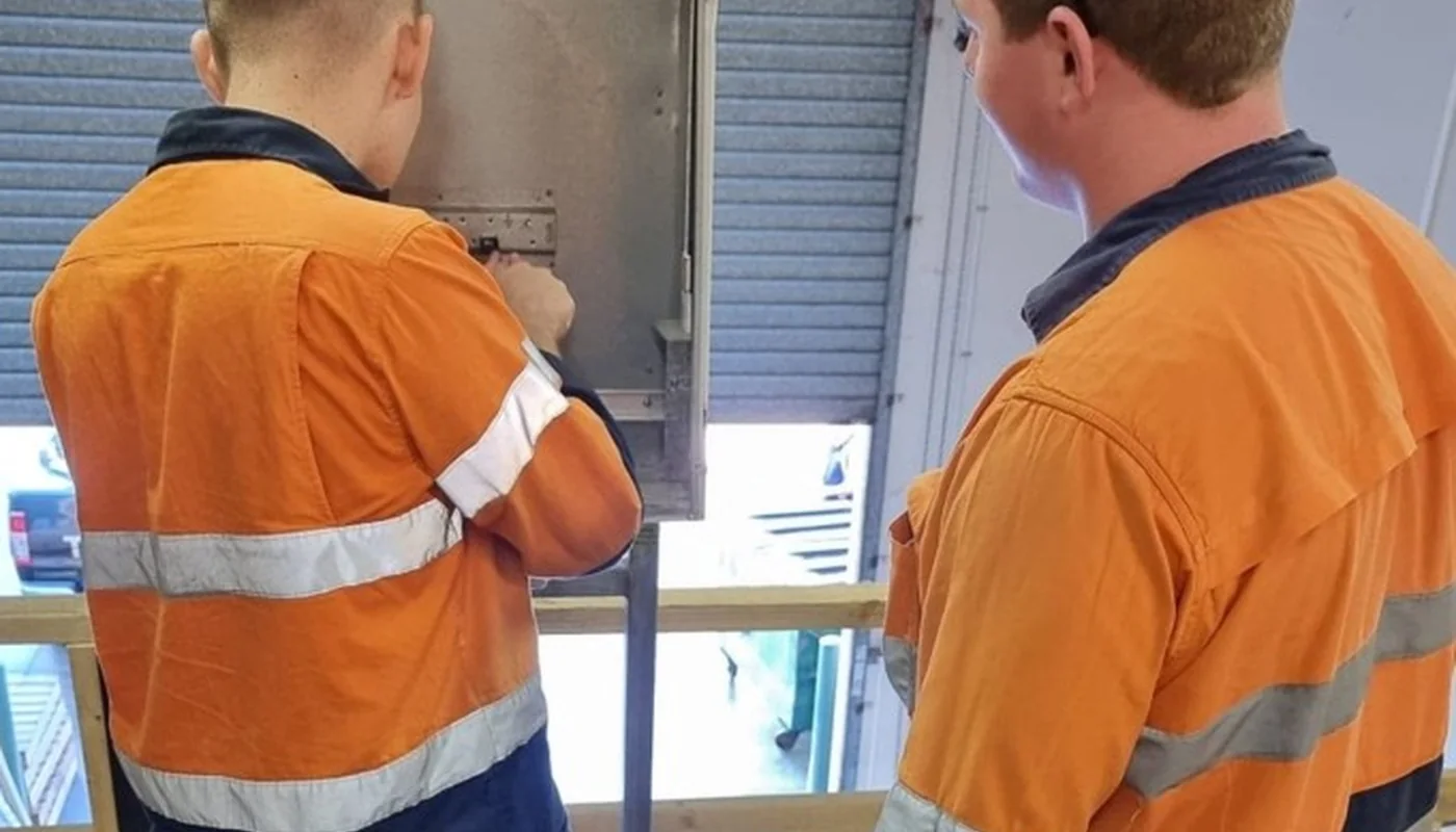 Two EDC Systems apprentices learning practical electrical skills